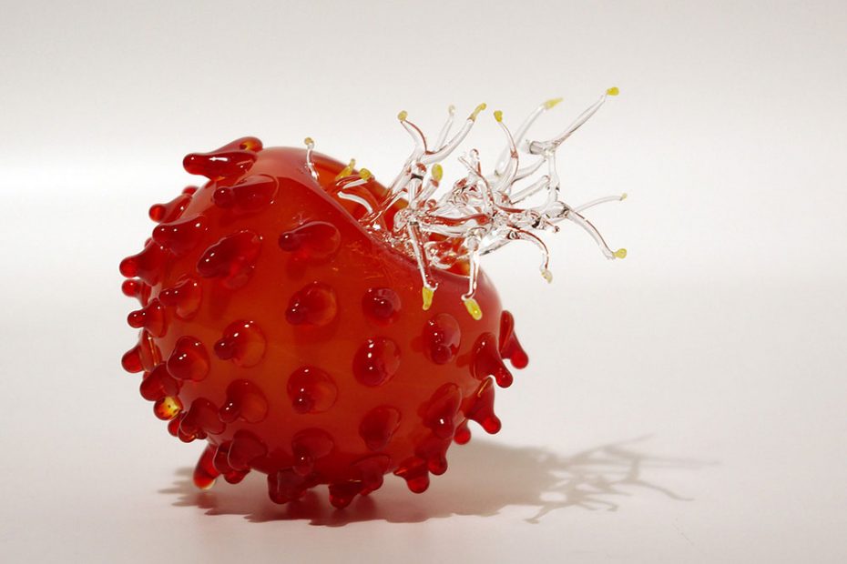 A red blown glass thistle with clear threads string growing out.